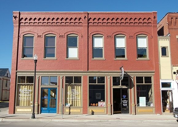 Historic red-brick downtown storefront with ornate upper facade